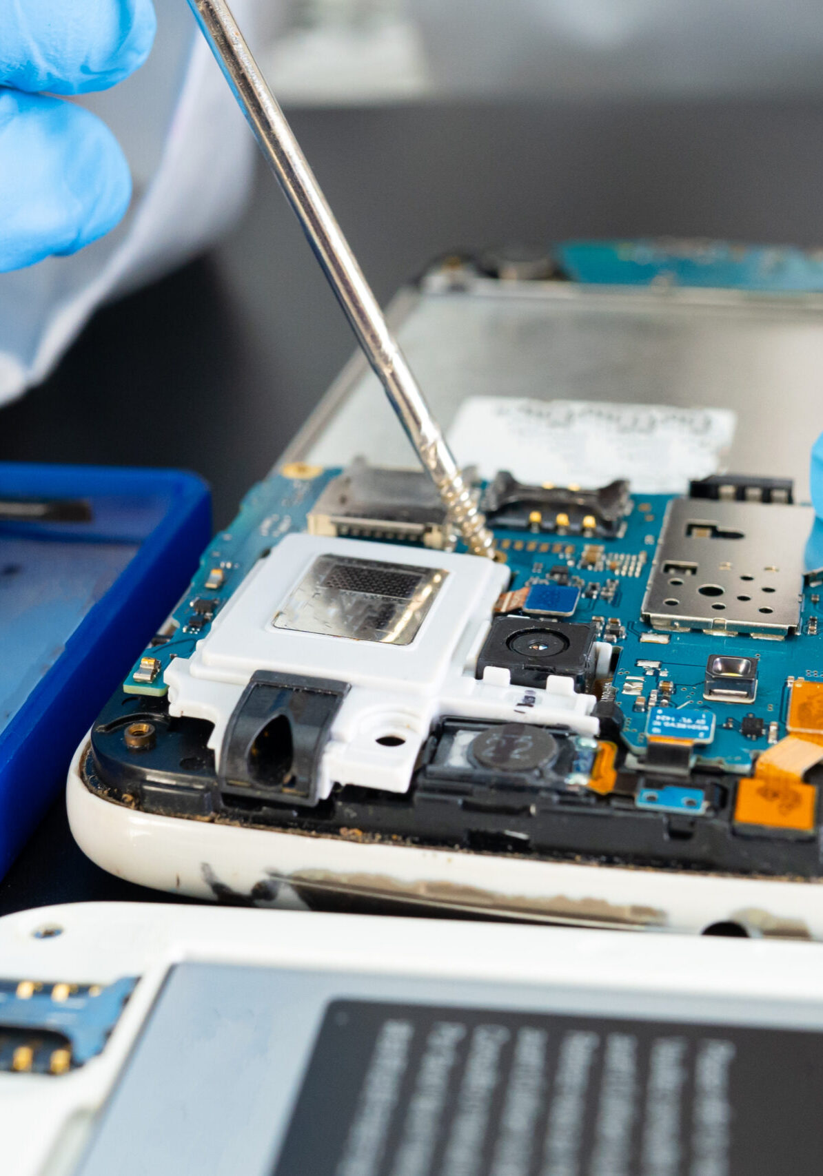 Technician repairing inside of mobile phone by soldering iron. Integrated Circuit. the concept of data, hardware, technology.